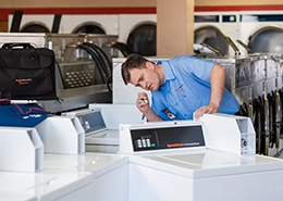 Mr. Appliance tech working on commercial dryer.